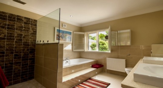 Bathroom with bathtub and rain shower